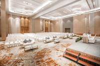 an empty banquet hall with white chairs and tables at HARRIS Hotel Batam Center in Batam Center