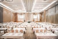a large banquet hall with white tables and chairs at HARRIS Hotel Batam Center in Batam Center