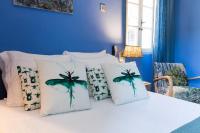 a blue bedroom with a bed with four pillows at Le Jardin d&#39;Emile in Cassis