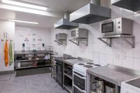 a kitchen with stainless steel appliances in a kitchen at Astor Hyde Park Hostel in London