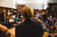 a person sitting in a crowd of people at Astor Hyde Park Hostel in London
