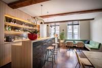 a living room with a bar and a green couch at Hotel Augustyn Brugge in Bruges