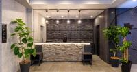 a bathroom with a stone wall and a bath tub at HOTEL SUI AKASAKA by ABEST in Tokyo