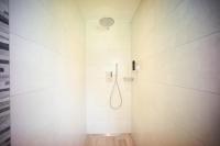 a white bathroom with a shower with a shower head at Hotel Klosterhotel Ludwig der Bayer in Ettal