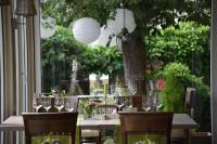 a table with wine glasses and flowers on it at Weingut und Gästehaus Zilliken in Nittel