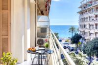 a balcony with a table and a view of the ocean at #29 Suite Gambetta AC Sea view 2 bedrooms 1min Walk to Promenade &amp; Sea in Nice