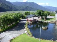 a boat in a river with a gazebo at Ying Shih Guest House in Datong