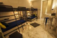A bed or beds in a room at Ostello degli Elefanti