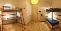 A bed or beds in a room at Ostello degli Elefanti
