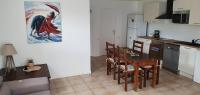 a kitchen and dining room with a table and chairs at Bel appartement dans hameau calme in Bonifacio