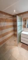 a bathroom with wooden walls and a sink in a room at Bel appartement dans hameau calme in Bonifacio