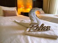 A bed or beds in a room at Royal Beach Premium
