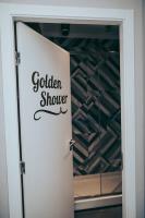 a white door with a golden shower sign on it at Gspot Hostels & Love Triangles Pizzeria in Lisbon