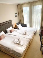 A bed or beds in a room at Royal Beach Premium