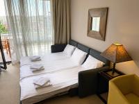 A bed or beds in a room at Royal Beach Premium