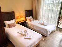 A bed or beds in a room at Royal Beach Premium