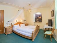 a bedroom with a large bed and a television at Hotel Plankl in Altötting