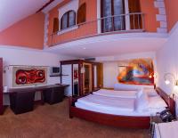 a bedroom with a large bed with a balcony at Bavaria Lifestyle Hotel in Altötting