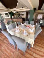 KakanjにあるMotel Tironのダイニングルーム(大きな白いテーブルと椅子付)