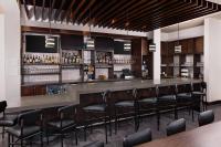 a bar with black stools in a restaurant at Hyatt Place Florence Downtown in Florence