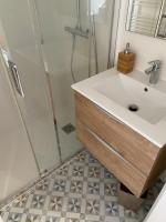 a bathroom with a sink and a shower at Villa st Louis 2 in Cabourg