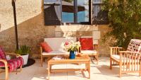 a patio with chairs and a table with flowers on it at Maison d hôtes Casa Sana in Pillac