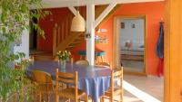 a dining room with a table and chairs and a staircase at Maison d hôtes Casa Sana in Pillac