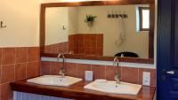 a bathroom with two sinks and a large mirror at Maison d hôtes Casa Sana in Pillac