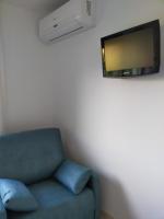 Televízia a/alebo spoločenská miestnosť v ubytovaní A Postiña