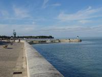 a pier next to the water with people walking on it at Studio Vue Mer in Saint-Martin-de-Ré