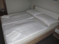 A bed or beds in a room at A+S Penzion Podzamok