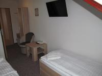 A bed or beds in a room at A+S Penzion Podzamok
