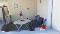 a balcony with a table and two glasses of wine at Krotiri Bay -adults only in Parikia