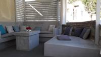 a patio with couches and a table in a room at Krotiri Bay -adults only in Parikia