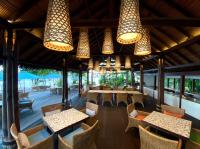 a restaurant with tables and chairs and lights at Moro Ma Doto in Busobuso