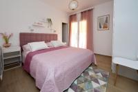 Postel nebo postele na pokoji v ubytování Apartmani Marta