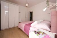 Postel nebo postele na pokoji v ubytování Apartmani Marta