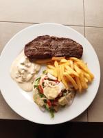 a plate of food with a sandwich and french fries at Hotel le Trarza in Niaga