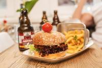 Un sándwich y papas fritas y una botella de cerveza. en Hagen`s Hotel "eat & meet" Restaurant Bar Lounge, en Haren