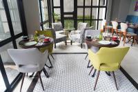 een eetkamer met een tafel en stoelen en een tafel en stoelen bij Barito Mansion in Jakarta