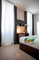 Łóżko lub łóżka w pokoju w obiekcie Sanremo Luxury Suites