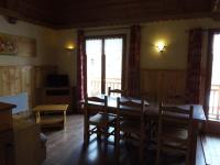 a dining room with a table and some windows at Chalet l&#39;aubépine résidence B&amp;B in Bessans