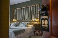 Postel nebo postele na pokoji v ubytování Hotel Posada de las Cuevas