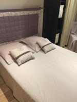 a bed with white sheets and pillows on it at Maison La Minoterie in Volonne