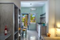 a small kitchen with a sink and a counter at Coralli Seaside Resort in Livadakia