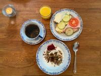 a table with two plates of food and a cup of coffee at Trollnäs Gårdshotell in Svärdsjö