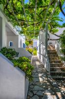 a walkway leading up to a building with stairs at Coralli Seaside Resort in Livadakia