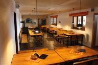 a dining room with wooden tables and chairs at Masarykova chata na Beskydě in Bumbalka