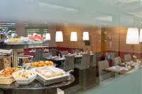 a restaurant with a buffet of food on a table at Holiday Inn Vienna City by IHG in Vienna