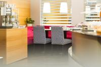 a restaurant with two chairs and a red couch at Holiday Inn Vienna City by IHG in Vienna